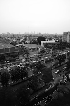A cityscape with delivery vehicles on the road.