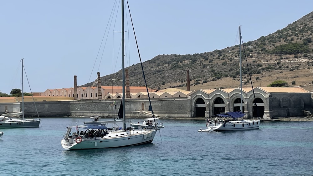 a group of boats floating on top of a body of water