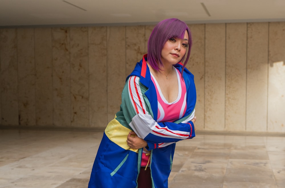 a woman with purple hair and a colorful outfit