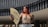 a woman with red hair is holding a fan
