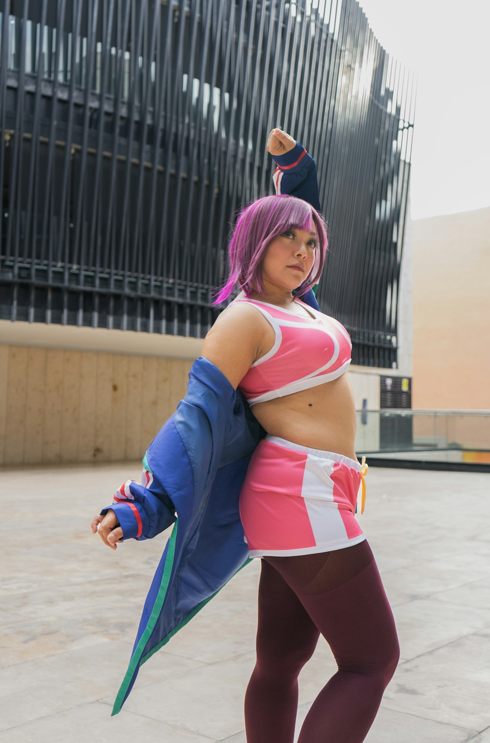 a woman dressed in a cosplay poses for a picture