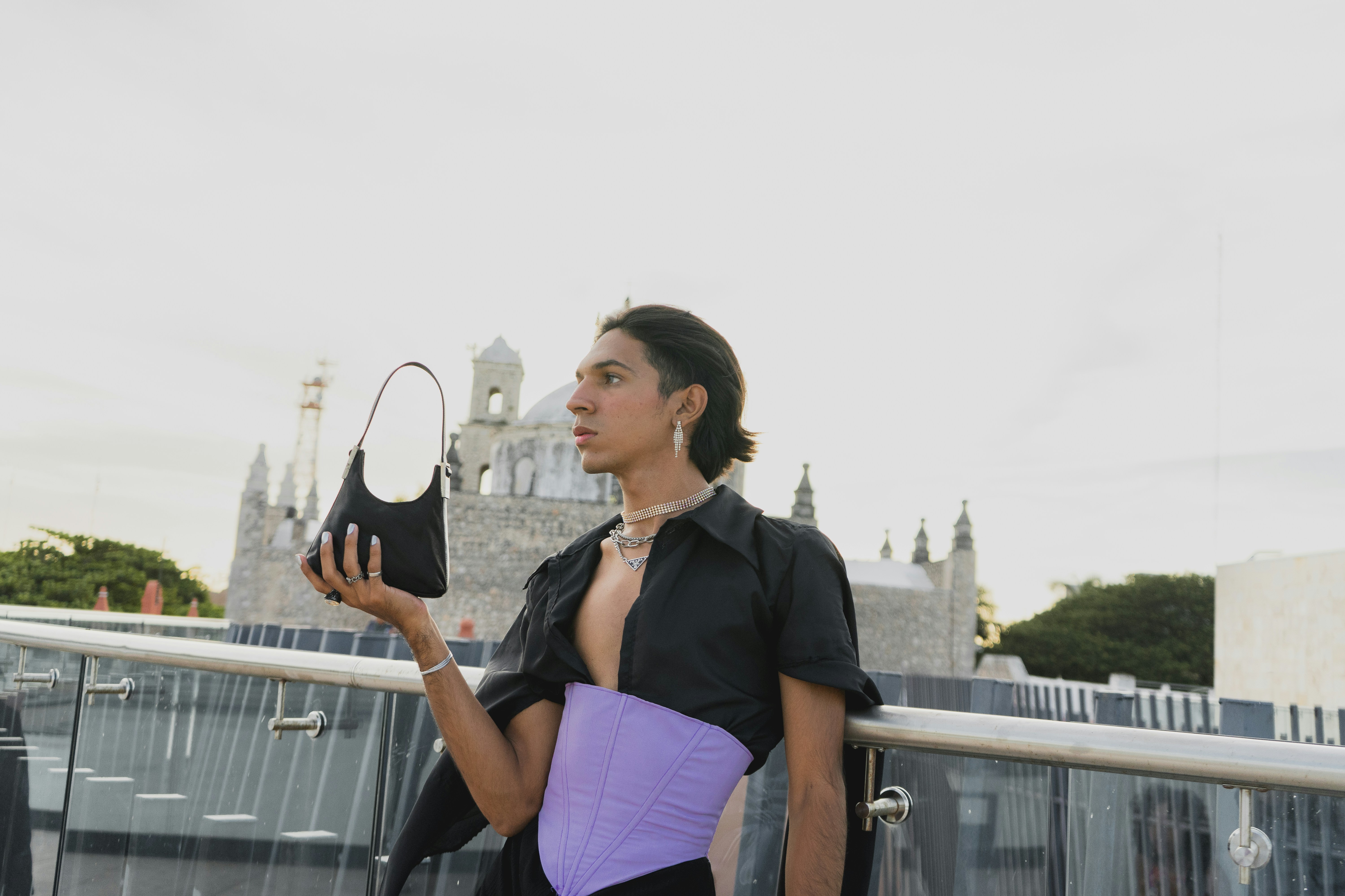 a woman in a black shirt holding a purple purse