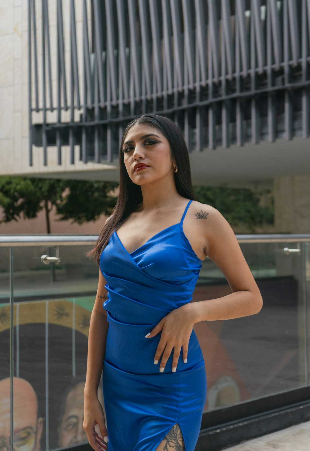 a woman in a blue dress posing for a picture