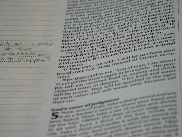 A close-up of a page from a book with printed text and handwritten notes in the margins. The text appears to be in English and consists of paragraphs, while the handwritten notes include a question.