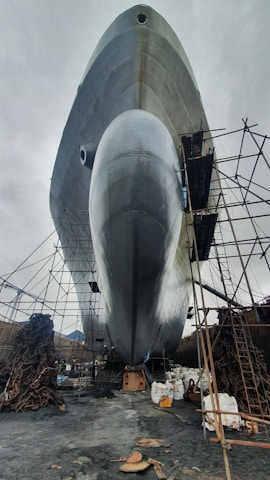 A wide shot of a large vessel lifted out of water for maintenance at the Teynham facility.