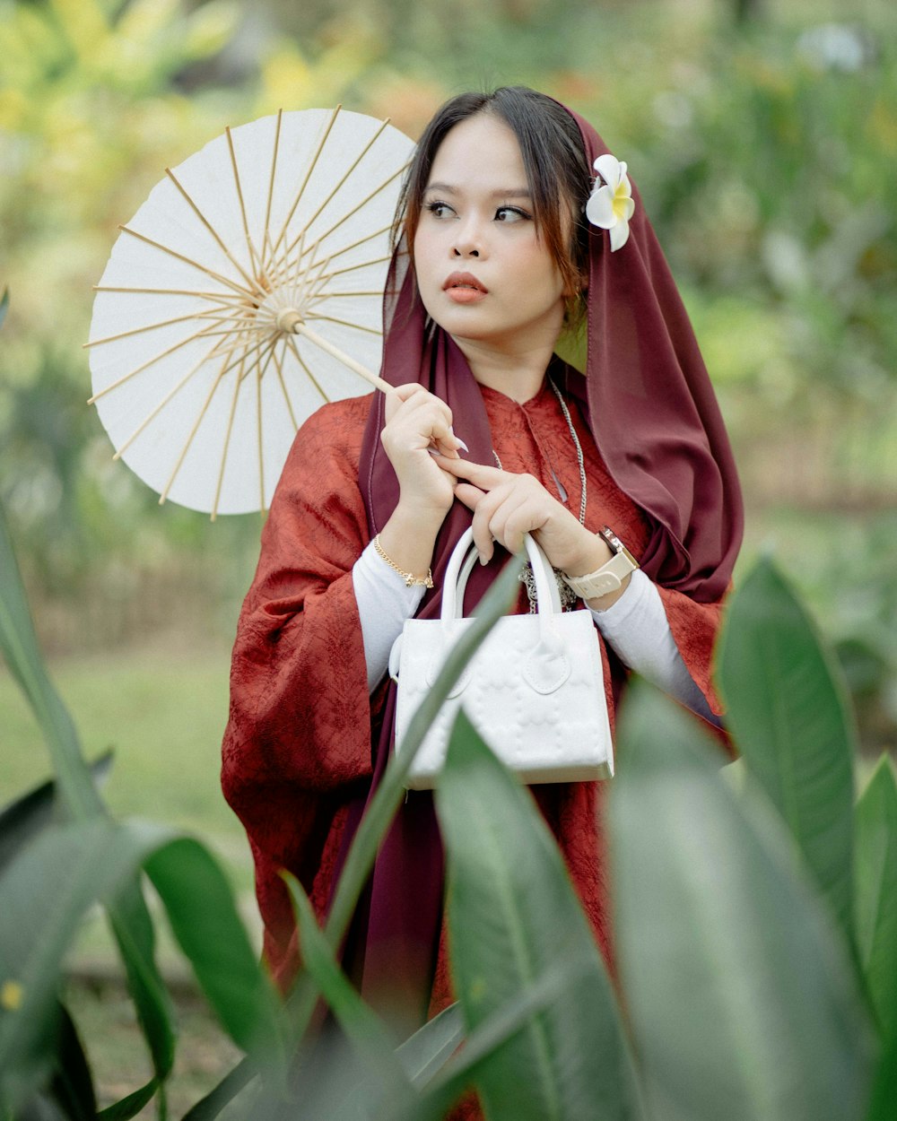 a woman in a kimono holding an umbrella