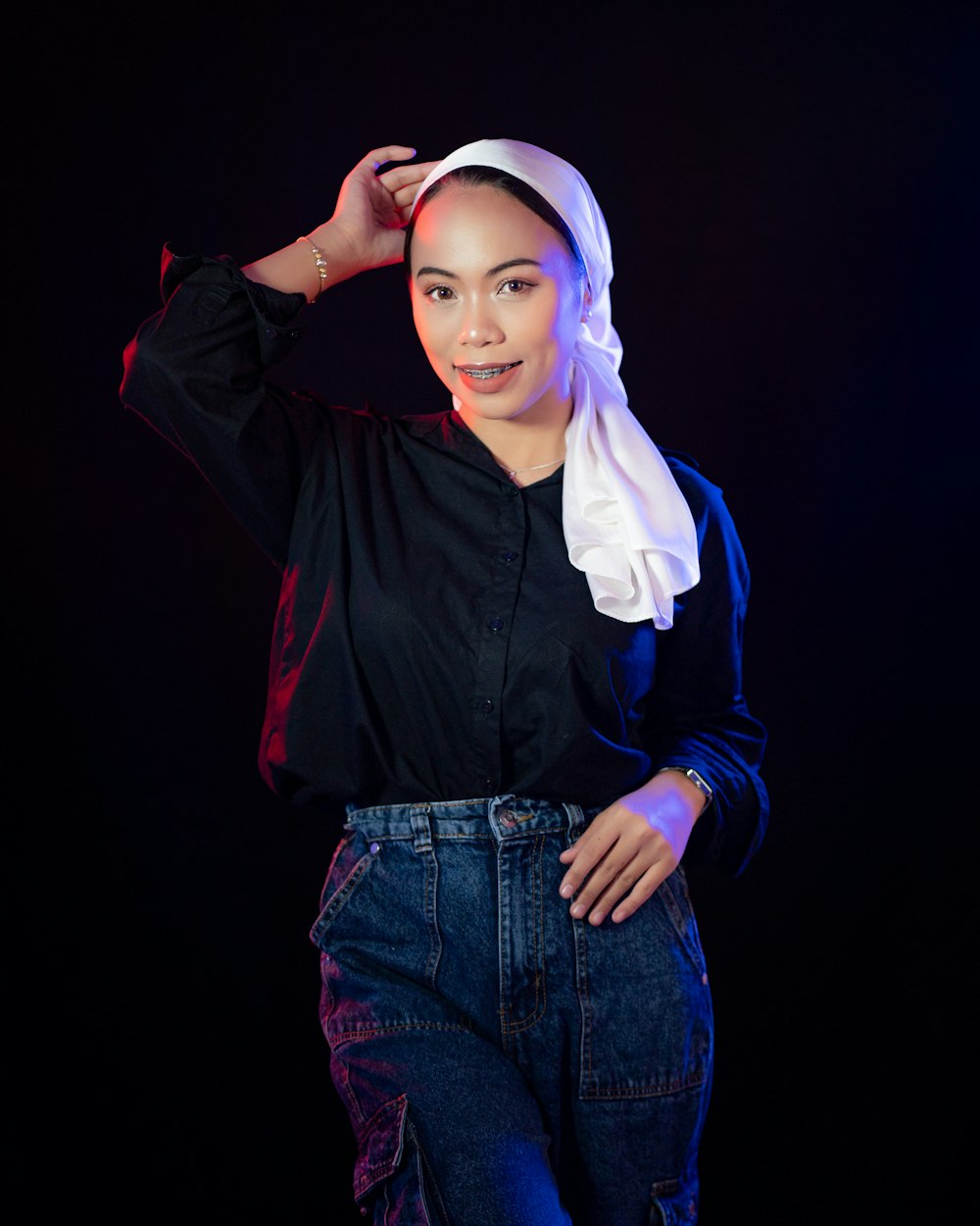 a woman in a black shirt and a white head scarf