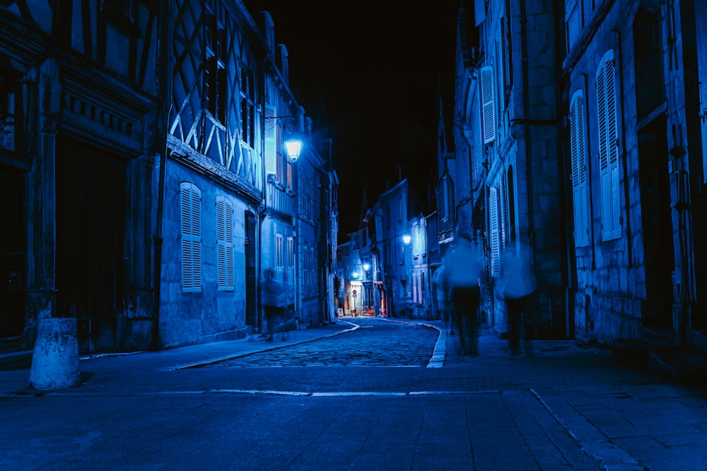 a person walking down a street at night