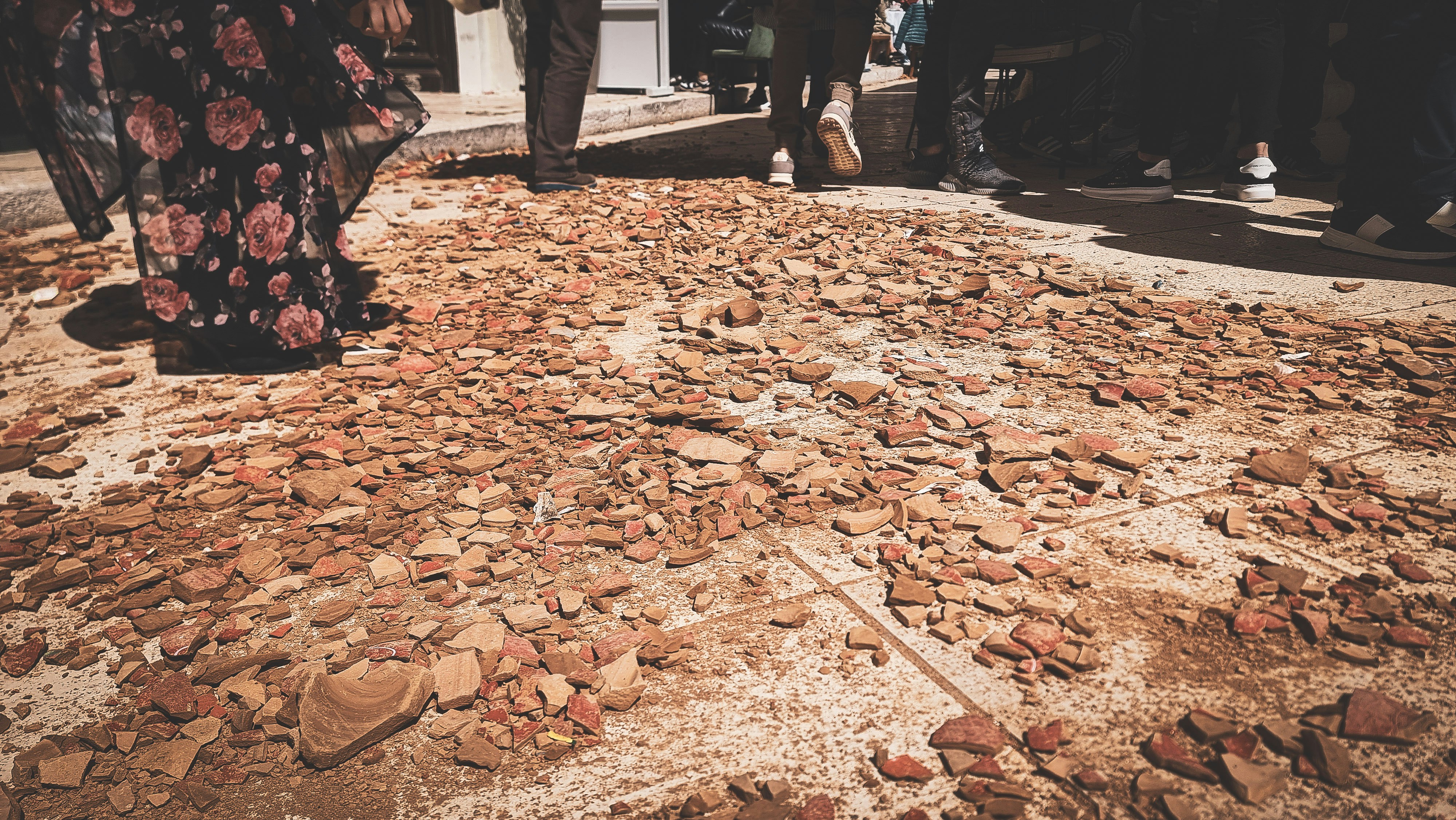 a group of people standing around a pile of rocks