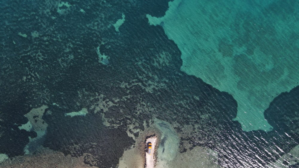 an aerial view of a boat in the water