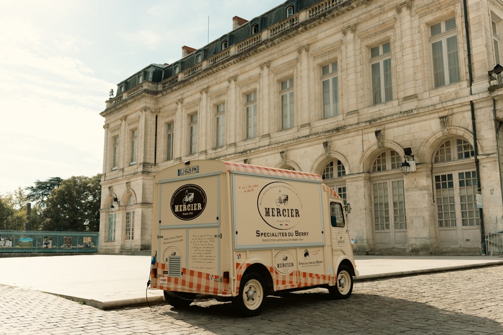 a food truck parked in front of a large building