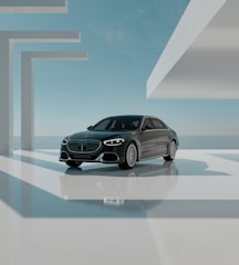 A sleek black-and-white photo of a modern luxury car parked in front of a minimalist building in Hohenlinden.