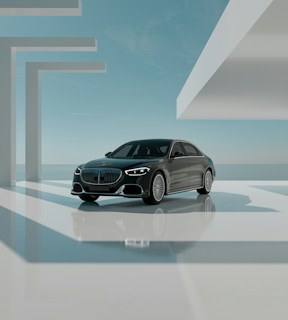 A sleek black luxury car is positioned in a modern, minimalistic architectural environment. The setting features geometric shapes and large, open spaces bathed in natural light. The sky is clear with subtle clouds, creating a serene backdrop. The car is prominently displayed, reflecting light off its polished surface.
