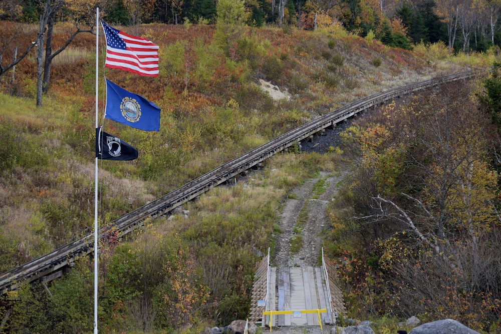 a flag flying next to a railroad track