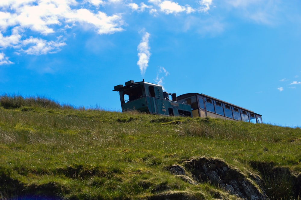 a building sitting on top of a lush green hillside