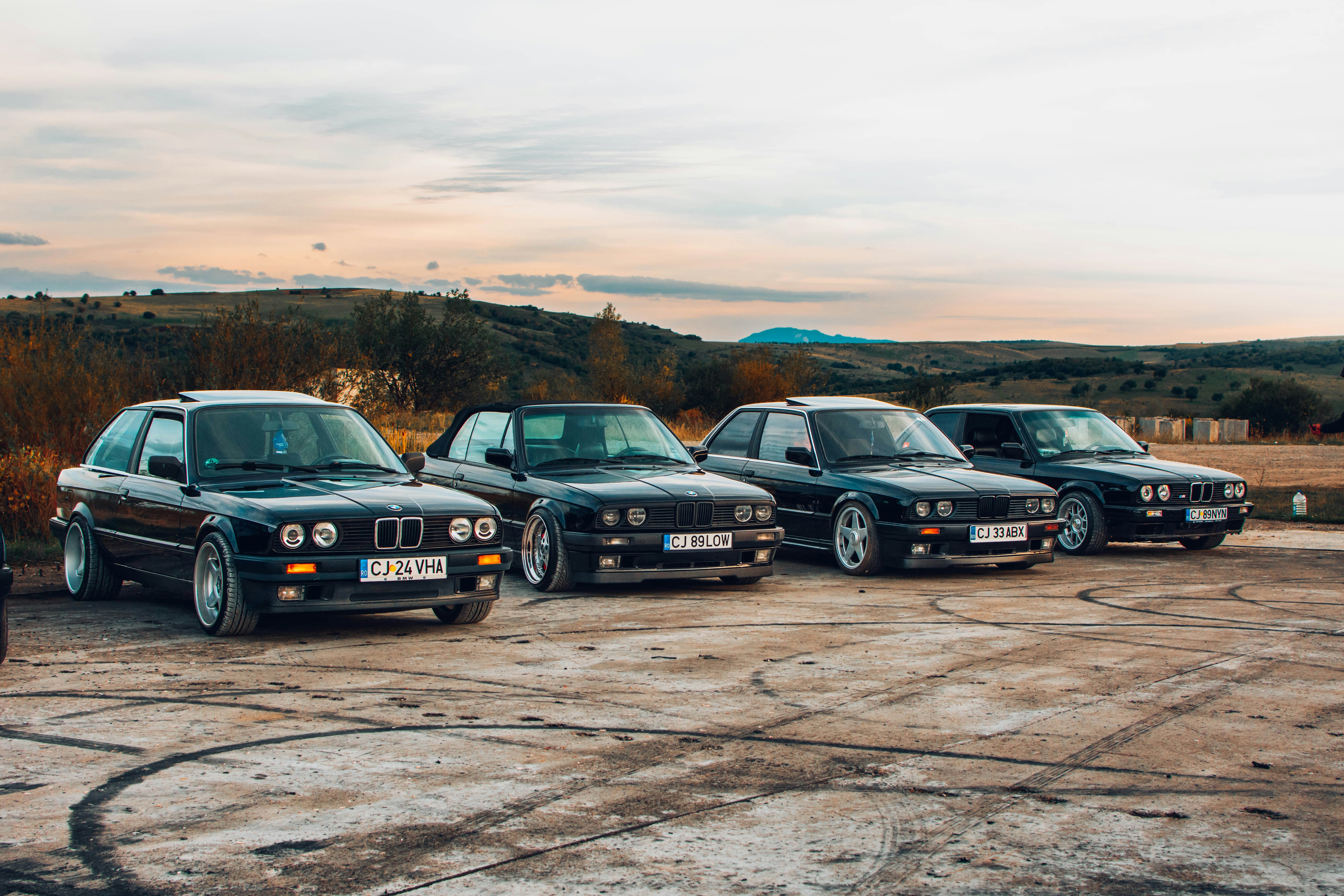 A group of four cars parked next to each other photo – Free Car Image ...