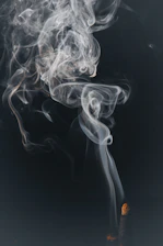 a cigarette with smoke coming out of it