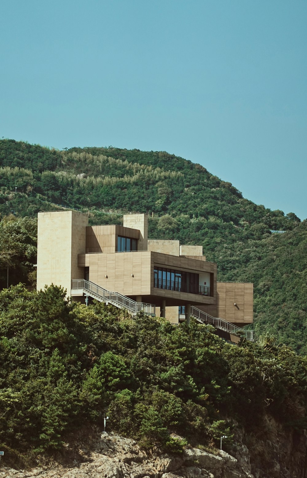 a building on a hill with a staircase leading up to it