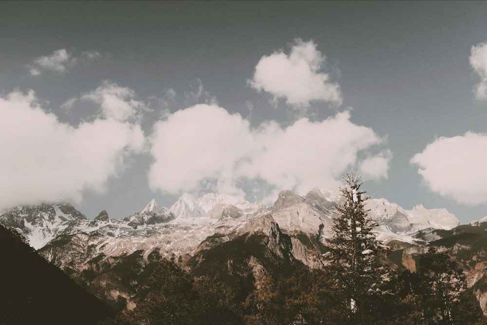 a view of a mountain range with clouds in the sky