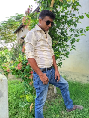 Lifestyle shot of a confident man walking outdoors surrounded by greenery, embodying vitality and wellness.