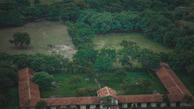 Aerial view of the academy nestled among olive groves and rolling hills.