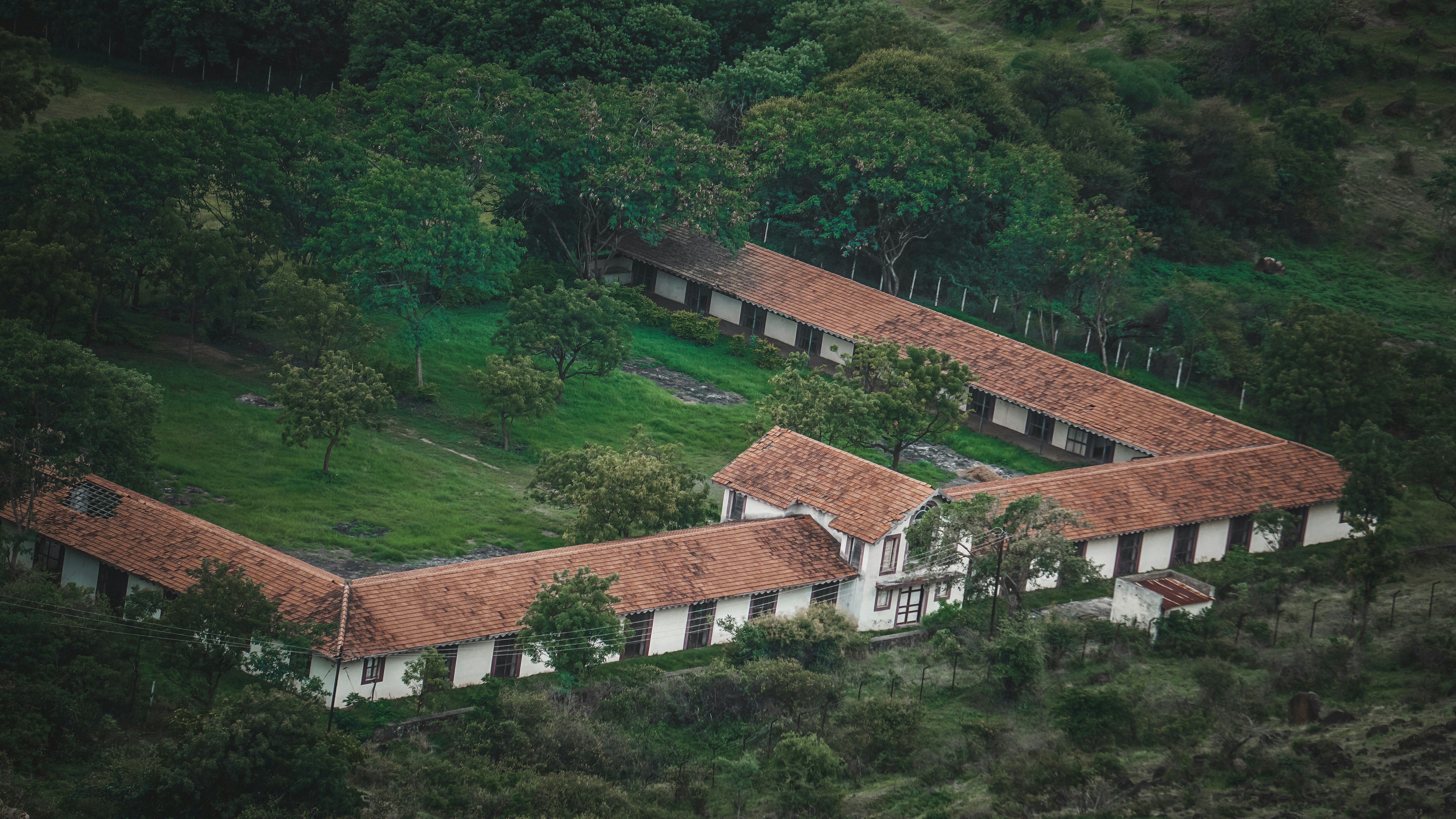 an aerial view of a house in the middle of a forest, Saswad, Pune