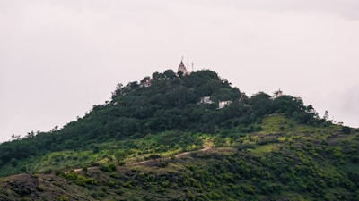 Lush green trails leading to the peaceful Tungnath shrine nestled among clouds.