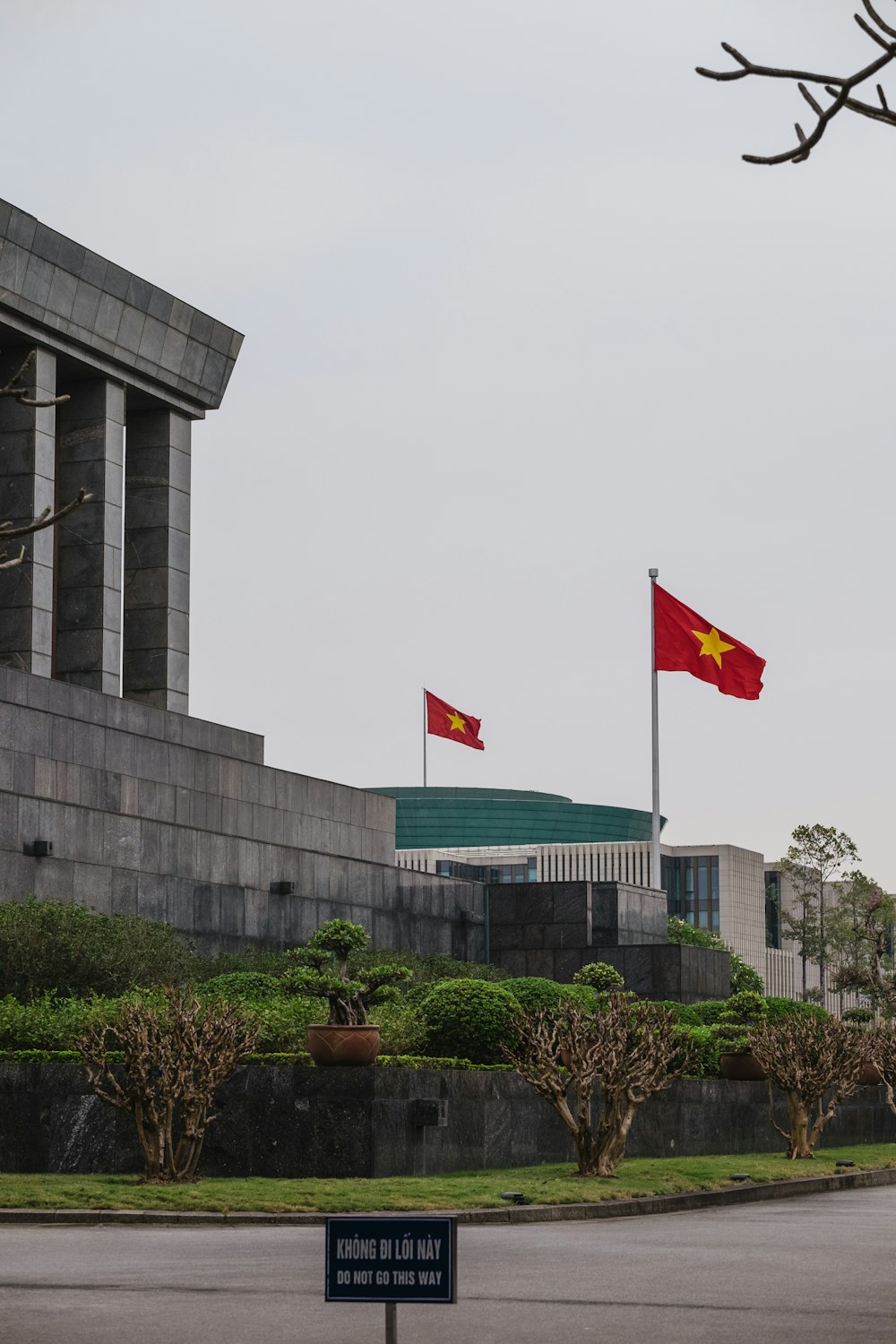 two flags flying in front of a building