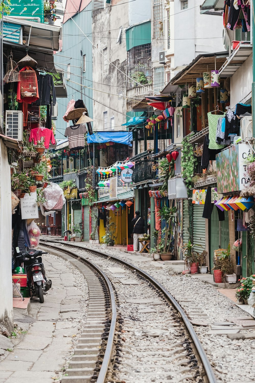 a train track running through a narrow city