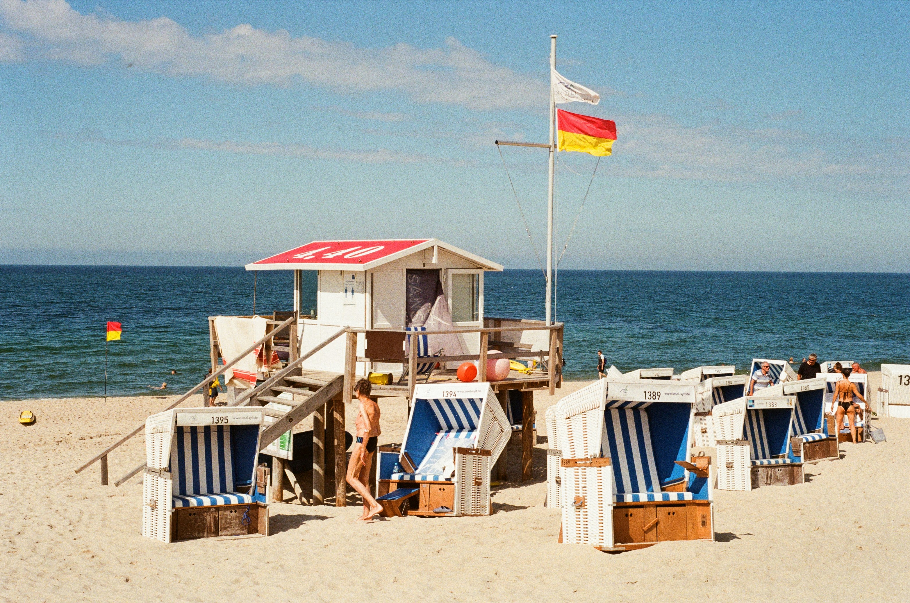 a group of beach chairs sitting on top of a sandy beach