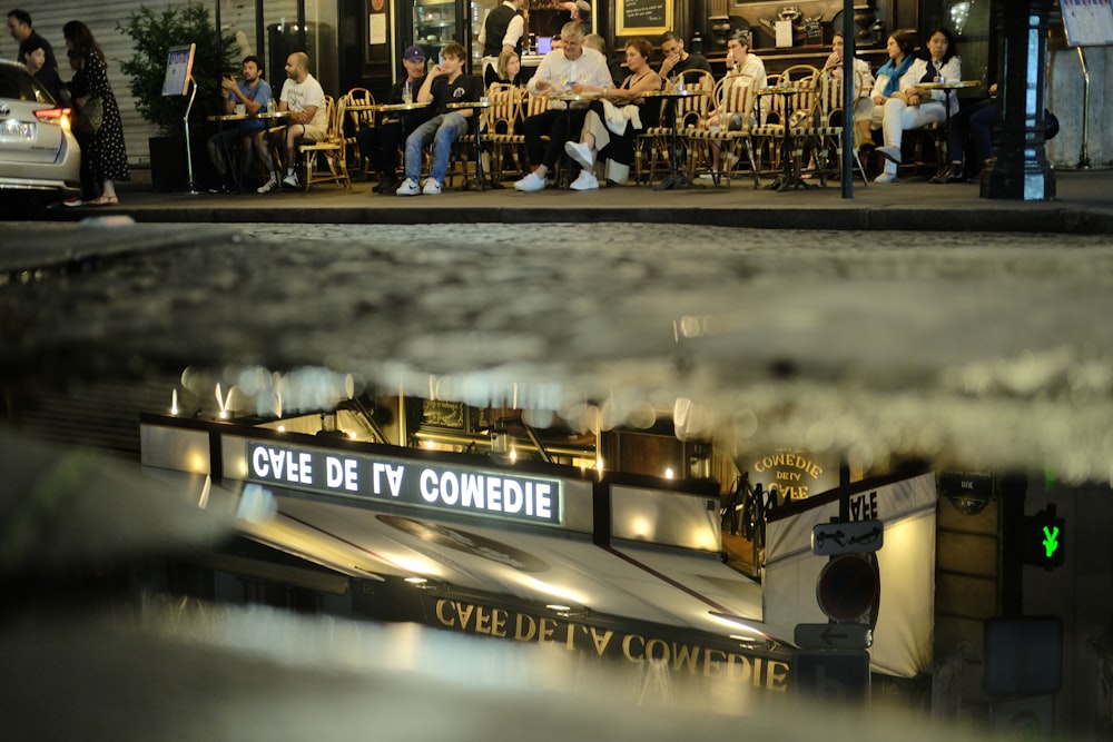 a group of people sitting outside of a building