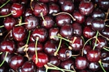 Close-up of ripe cherries glistening under the market’s warm lighting.
