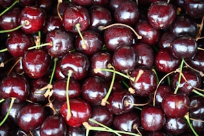 Close-up of ripe cherries glistening under the market’s warm lighting.