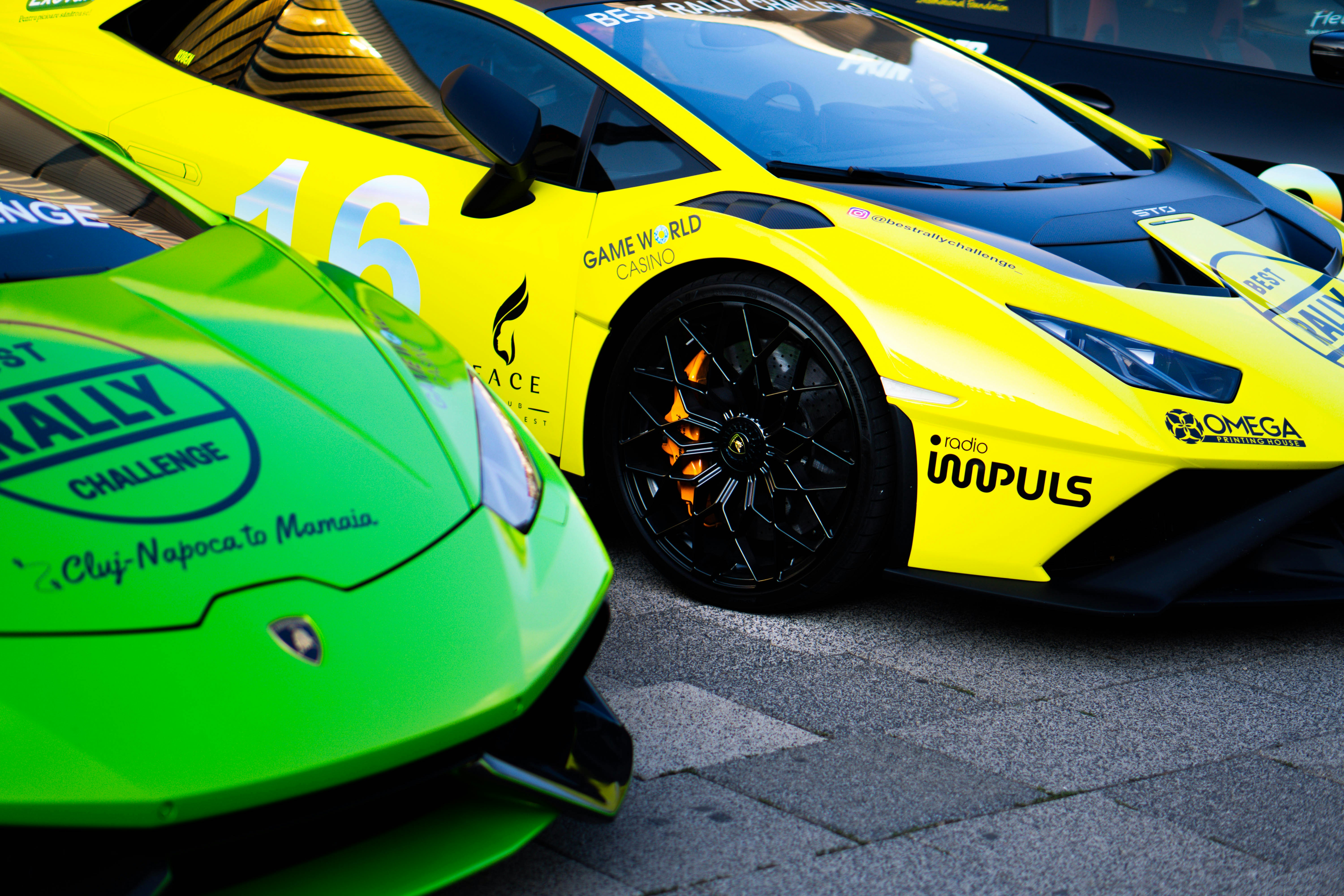 a couple of yellow sports cars parked next to each other