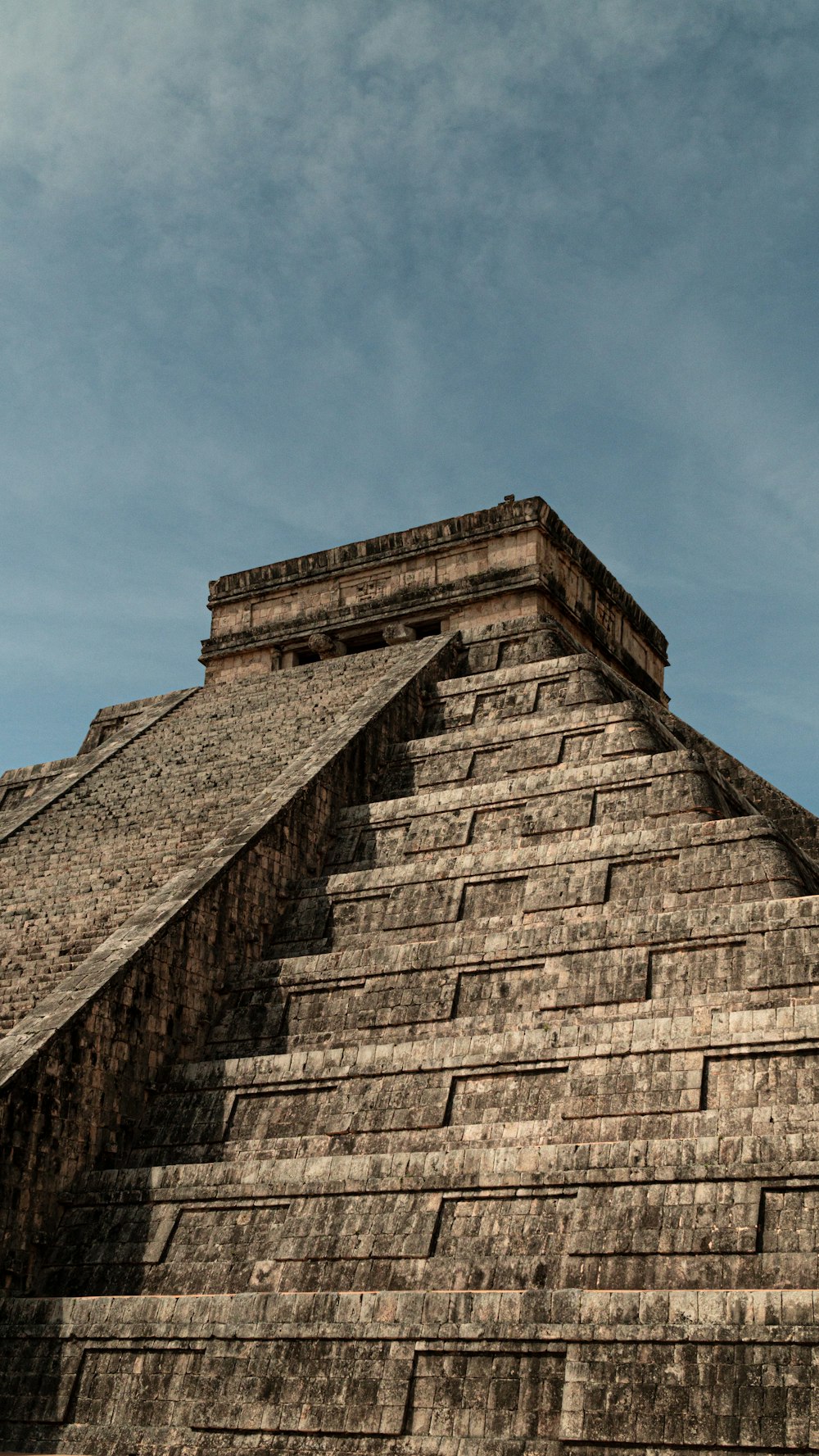 a very tall pyramid with a clock on it's side