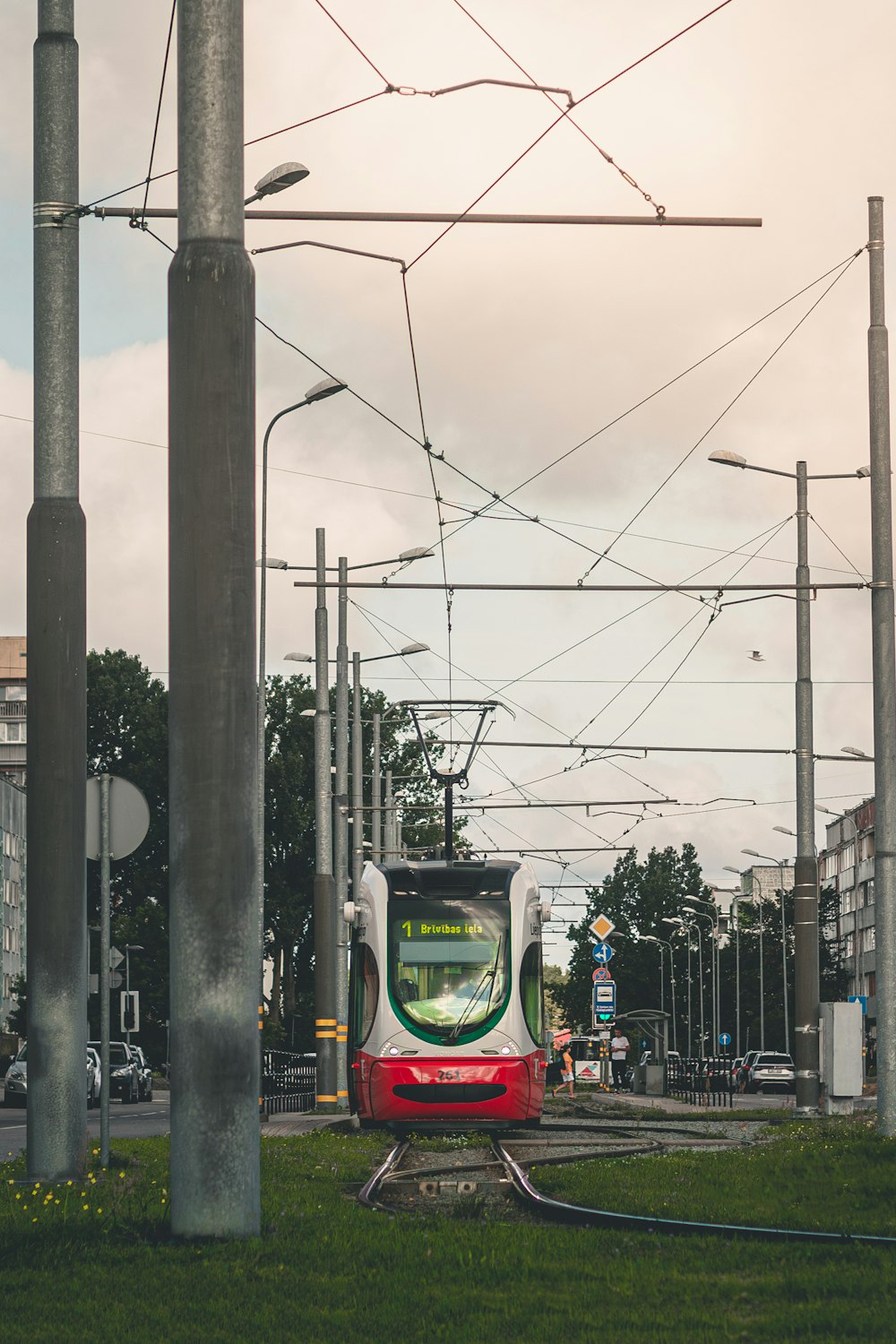 a red and white train traveling down train tracks