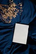 a blank book sitting on top of a blue sheet