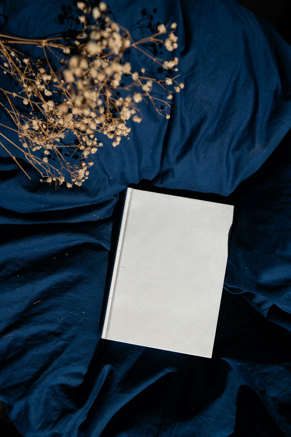 an open book sitting on top of a blue sheet
