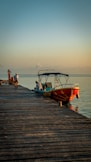 a boat is docked on a wooden pier