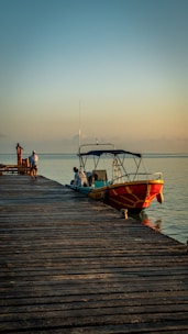 a boat is docked on a wooden pier