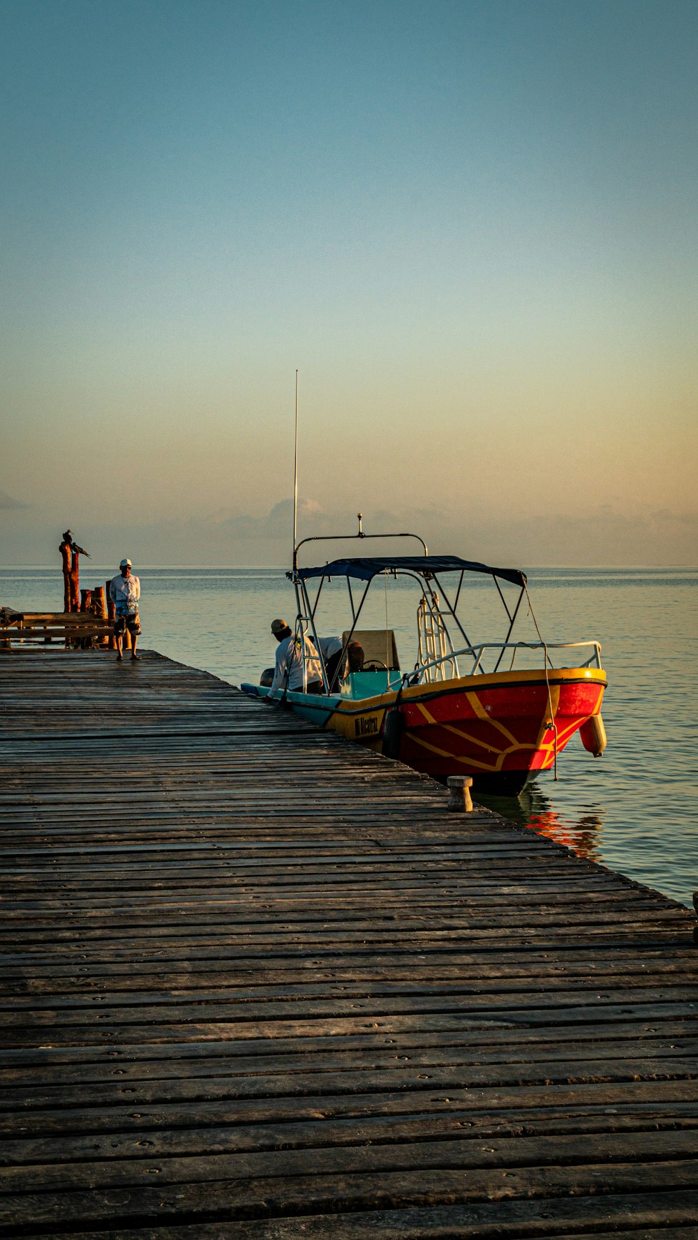 a boat is docked on a wooden pier