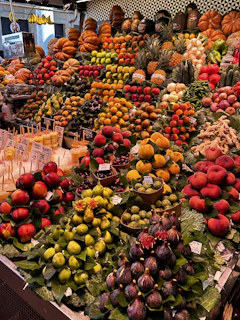 A lively market stall showcasing a variety of colorful fruits with the mascot playfully interacting.
