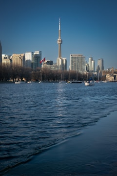 Anchor reading news with city skyline backdrop.