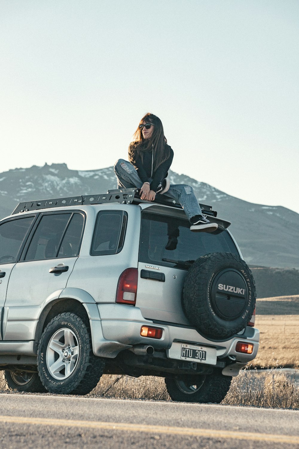 a woman is sitting on top of a vehicle