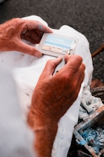 Close-up of hands carefully rolling paint on a wall in a senior's home.