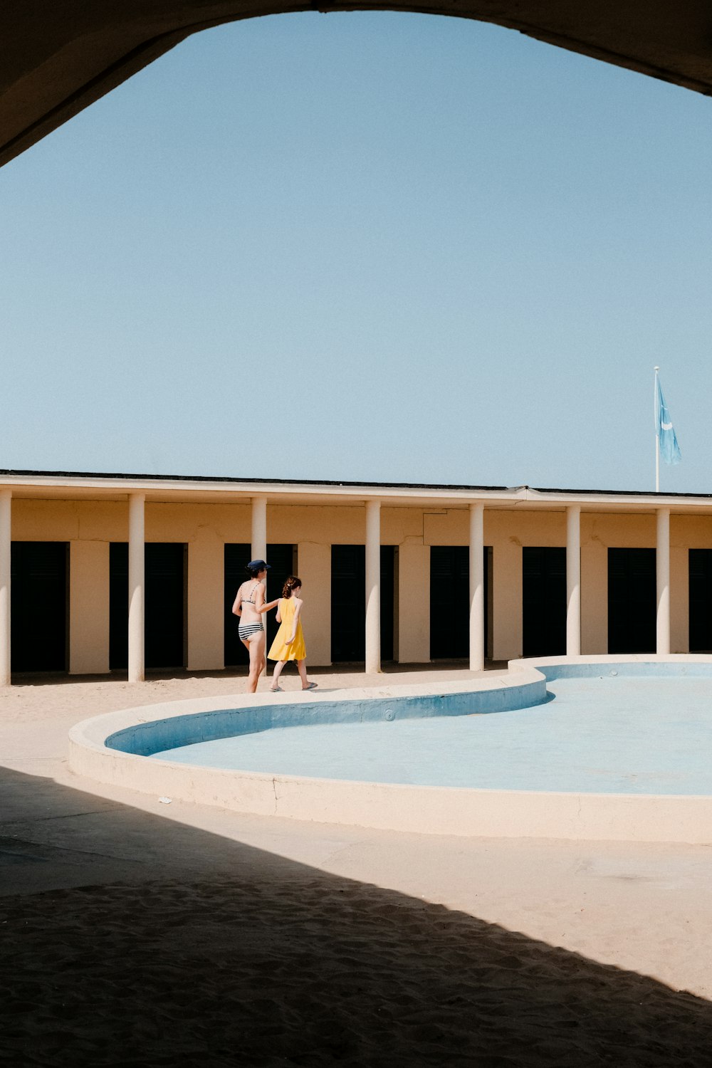 a woman standing in front of a swimming pool