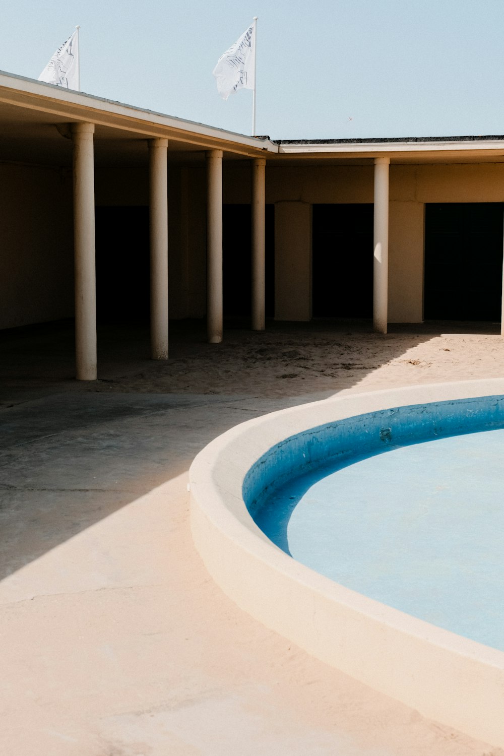 an empty swimming pool in front of a building