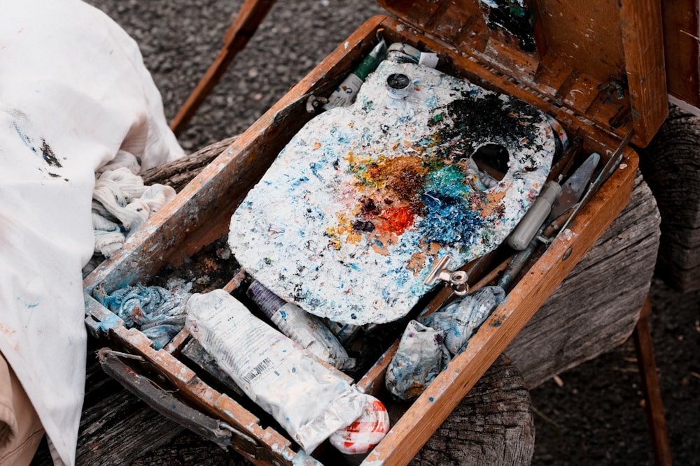 a wooden box filled with lots of paint