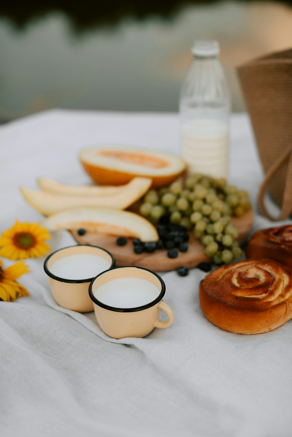 a table topped with plates and cups filled with food