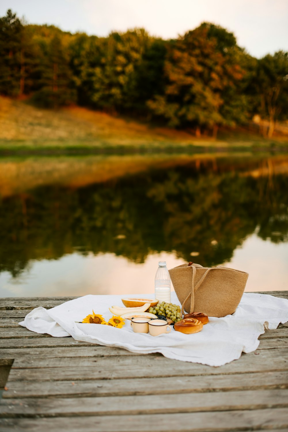 a picnic on a dock with a bottle of water and food